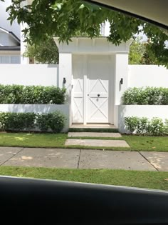 a house with a white door and some bushes