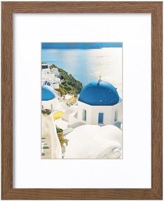 an image of a white and blue building with water in the background