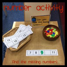 a wooden table topped with lots of different numbers and counting cards next to a bowl of cereal