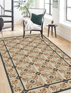 a living room area rug with an ornate design on the floor and stairs in the background