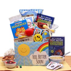 a box filled with lots of goodies sitting on top of a wooden table next to a bowl of cereal