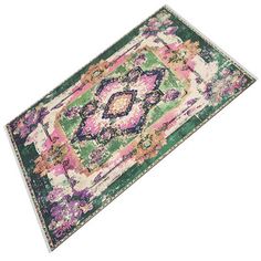 an area rug with various colors and patterns on the floor, including pink, green, purple