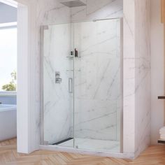 a walk in shower sitting next to a bathtub and wooden floored bathroom with white walls