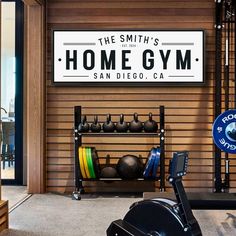 there is a gym sign in the background with an exercise bike and equipment on display