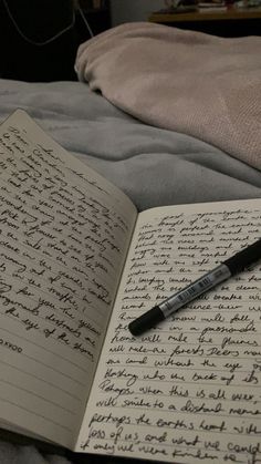 an open notebook with writing on it and a pen resting on the book's page