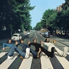 the beatles are laying down in the middle of the street