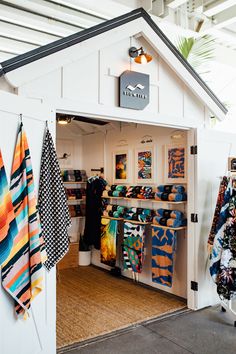 the inside of a shop with towels hanging on hooks