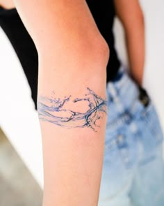 a woman with a tattoo on her arm