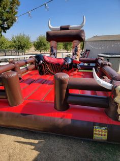 an inflatable bouncy castle with bull heads and horns on the top