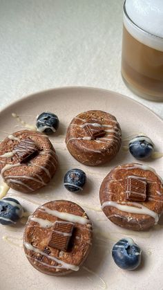 some blueberry donuts are sitting on a plate