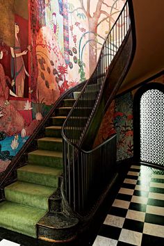 the staircase is decorated with colorful wallpapers and art on it's walls