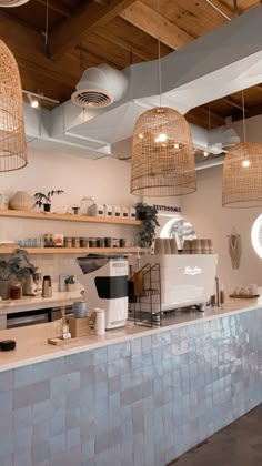 the interior of a coffee shop with hanging wicker baskets above the counter and on the ceiling