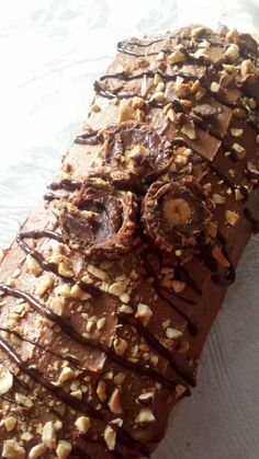 there is a chocolate pastry with nuts on it