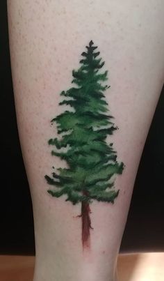 a green tree tattoo on the leg