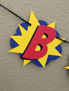 a sign that is on the side of a building with a blue, yellow and red b