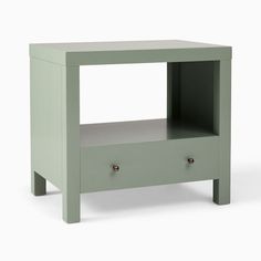 a small green table with two drawers