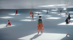 a group of people standing around in the middle of a room filled with white squares