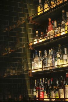 shelves filled with liquor bottles in a dimly lit room