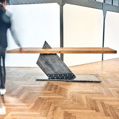 a wooden bench sitting on top of a hard wood floor