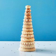 a stack of cookies sitting on top of a white table next to a blue wall