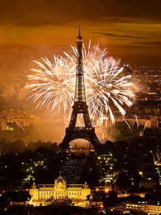 the eiffel tower is lit up with fireworks