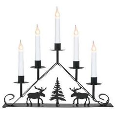 a candle holder with candles in the shape of a deer and pine tree