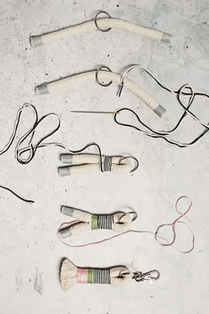 several pairs of scissors and cords laid out on the ground