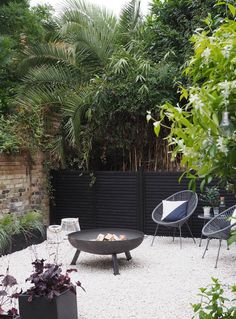 an outdoor patio with chairs, tables and plants