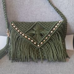 a green purse sitting on top of a chair