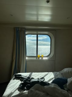 there is a window in the side of a boat that looks out on the water