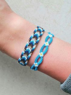 a woman's arm with two bracelets on it, one is blue and the other is brown