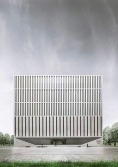 the building is white and has vertical lines on it's sides, making it appear to be made out of concrete