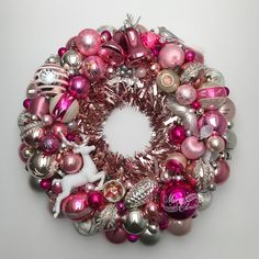 a pink and silver christmas ornament wreath