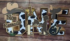 the word art is made out of wood and has animal images on it, including a cow