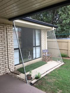 a house with a fence and grass in the front yard