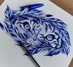 a drawing of a tiger's head with leaves on it and a blue marker