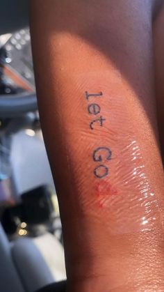 a person with a tattoo on their arm that says tea co written on the skin