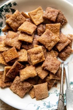 a white plate topped with croutons next to a fork