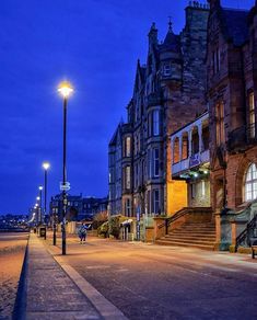 an empty city street is lit up at night