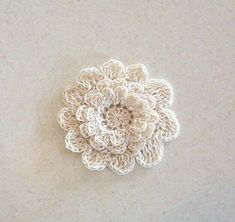 a crocheted flower on a white surface