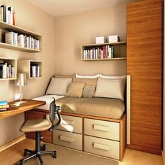 a small bedroom with a bed, desk and bookshelves on the shelves above it