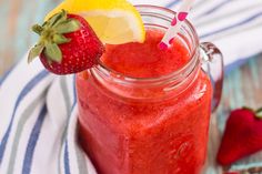 a strawberry lemonade smoothie in a mason jar with strawberries on the side