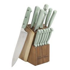 a knife block with knives in it and a wooden holder on the side that holds them