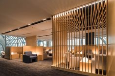 the interior of an office building with wooden partitions and chairs in front of them