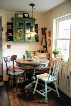 an old fashioned kitchen table with two chairs