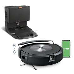 the robot vacuum is next to an electronic device