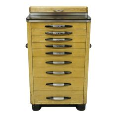 an old wooden cabinet with five drawers and six metal handles on wheels, all in different shapes and sizes