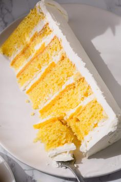 a slice of yellow cake on a white plate