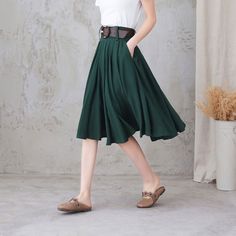 "Comfortable, gathered, a-line, knee-length skirt with high waistband. And it has pockets! This linen skirt will makes you a feminine and effortless look when paired with a tee or tank, and any of your well-loved heels, sneakers, clogs, flats, or sandals. On a breezy day, the wind sways your skirt like a sail. DETAIL * More colors * 50% linen, 50% cotton * No liner * Right hidden zipper closure * Two side pockets * with belt loops * High waistband * Pleated skirt * Knee length * Perfect for spri Pleated Green Full Skirt, Casual Green Pleated Full Skirt, Green Pleated A-line Skirt, Green Lined Midi Pleated Skirt, Green Skirt With Pleated Hem For Spring, Casual A-line Pleated Summer Skirt, Casual A-line Pleated Skirt For Summer, Flowy Knee-length Skirt For Work, Knee-length Flowy Skirt For Work