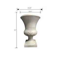 a white vase sitting on top of a table next to a tall ruler chart for measurements